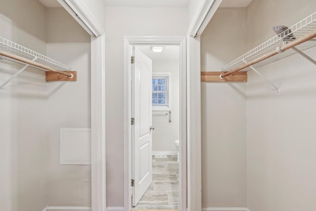 walk in closet featuring light hardwood / wood-style flooring