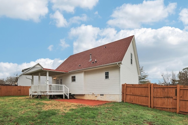 back of house featuring a deck and a yard