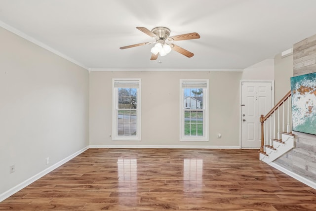 interior space featuring ceiling fan, wood-type flooring, and ornamental molding