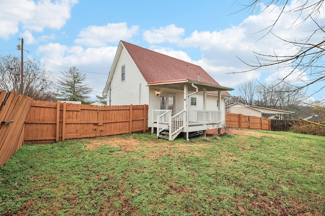 rear view of property with a lawn and a deck