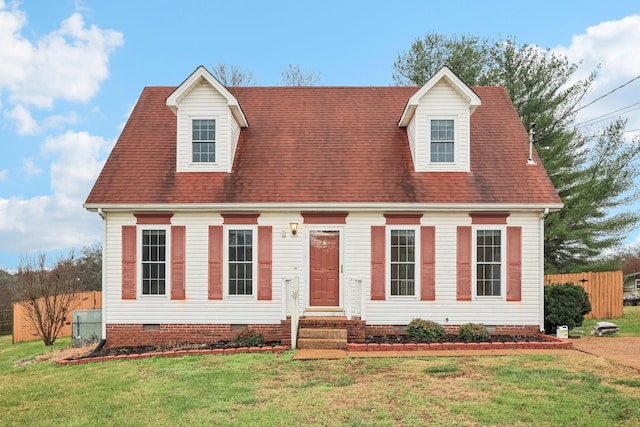 cape cod house with a front yard