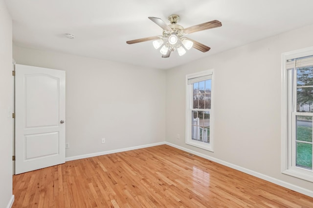 empty room featuring ceiling fan and light hardwood / wood-style floors