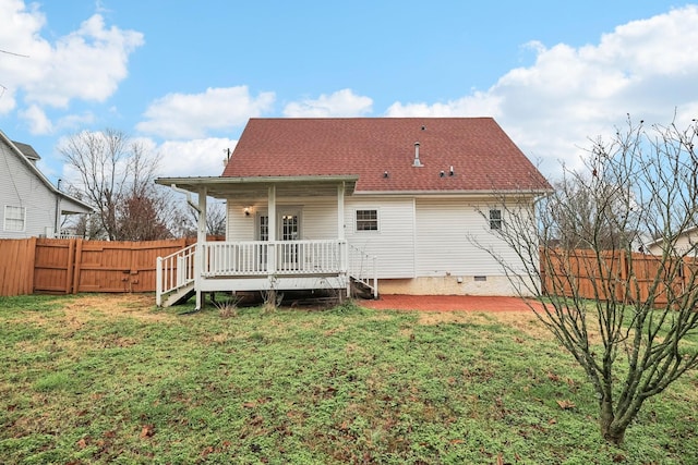 rear view of house featuring a yard and a wooden deck