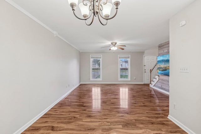 unfurnished living room with dark hardwood / wood-style flooring, ceiling fan with notable chandelier, and ornamental molding