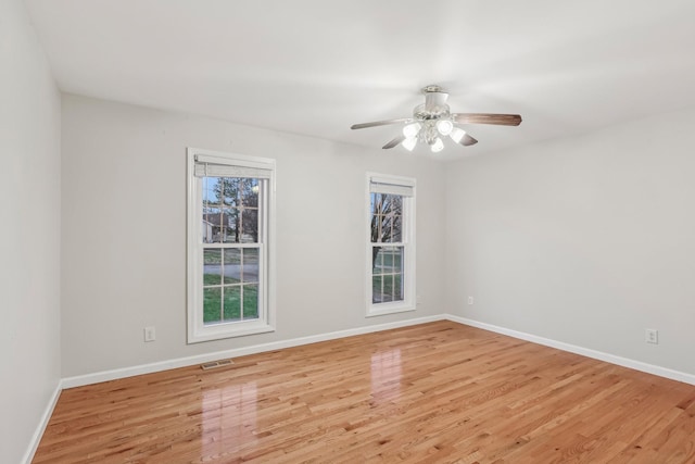 empty room featuring light wood-type flooring and ceiling fan