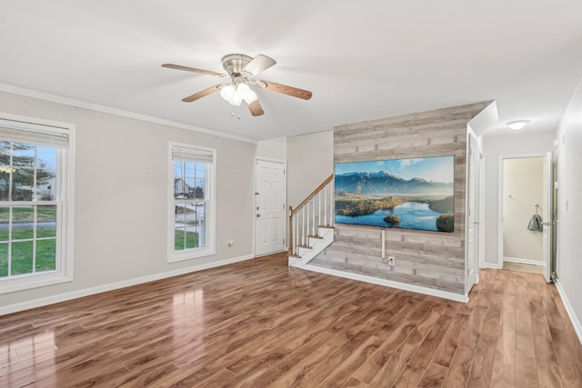 living room featuring ceiling fan, hardwood / wood-style floors, and ornamental molding