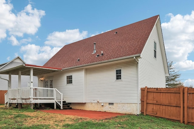 back of property featuring a lawn