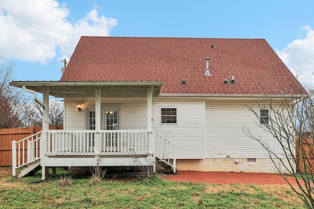 rear view of property with a lawn and covered porch