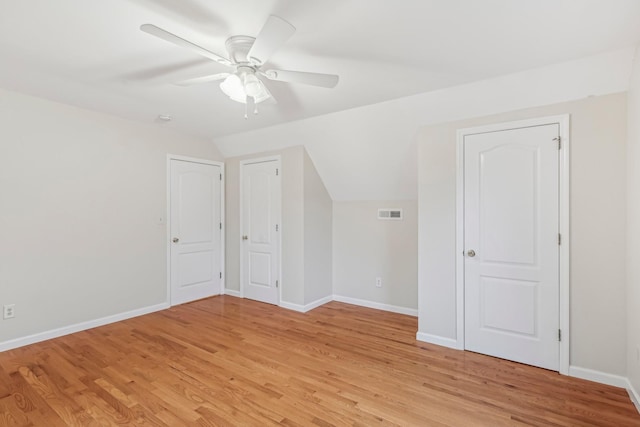 additional living space featuring ceiling fan, lofted ceiling, and light hardwood / wood-style flooring