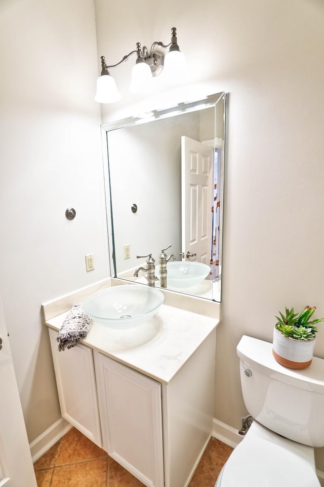 bathroom featuring tile patterned floors, vanity, and toilet