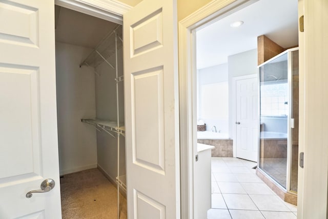 spacious closet featuring light tile patterned flooring