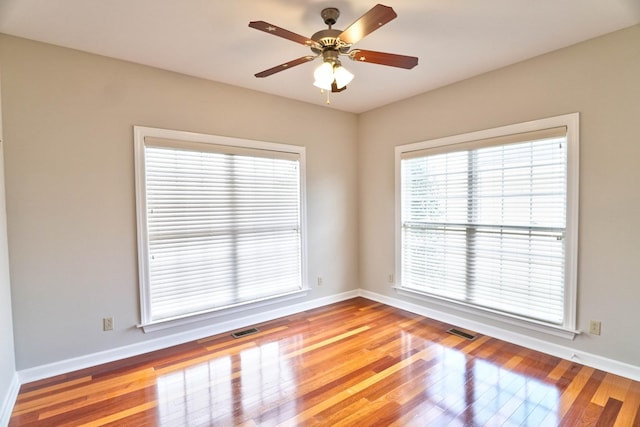 empty room with light wood-type flooring and ceiling fan