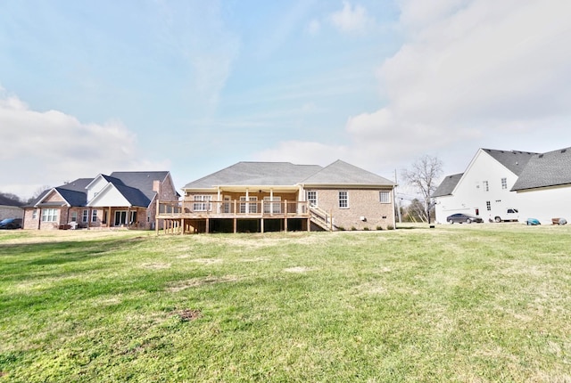 back of property featuring a lawn and a deck