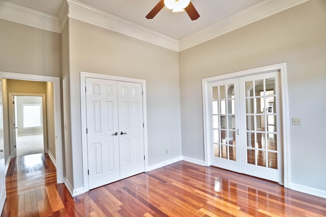 unfurnished bedroom with ceiling fan, wood-type flooring, ornamental molding, and french doors