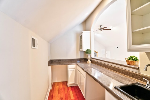 bar featuring hardwood / wood-style floors, vaulted ceiling, ceiling fan, and sink