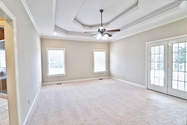 carpeted spare room featuring ceiling fan, ornamental molding, and a wealth of natural light