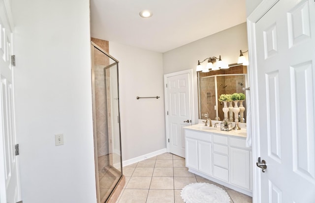 bathroom featuring tile patterned flooring, vanity, and an enclosed shower