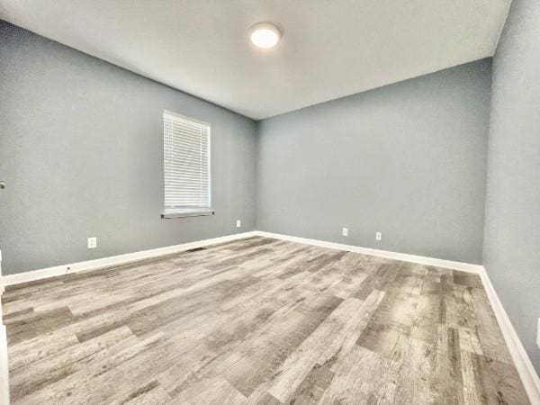 spare room with hardwood / wood-style floors