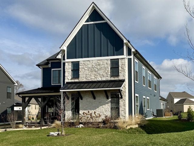 view of front of property featuring cooling unit and a front lawn