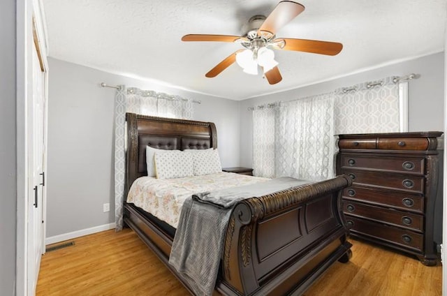 bedroom with light hardwood / wood-style flooring and ceiling fan