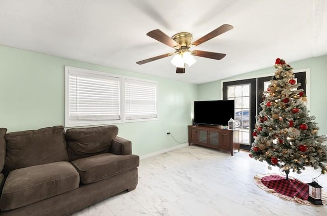 living room with ceiling fan, french doors, and lofted ceiling