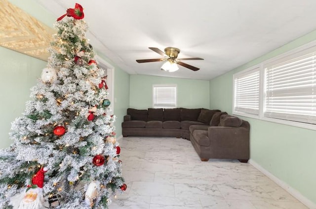 living room with vaulted ceiling, ceiling fan, and a healthy amount of sunlight