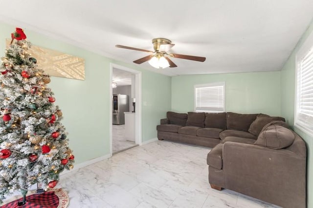 living room with a wealth of natural light and ceiling fan