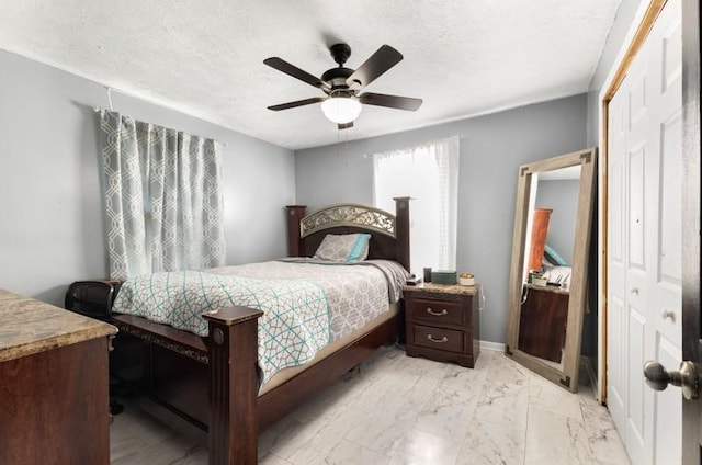 bedroom featuring a textured ceiling, a closet, and ceiling fan