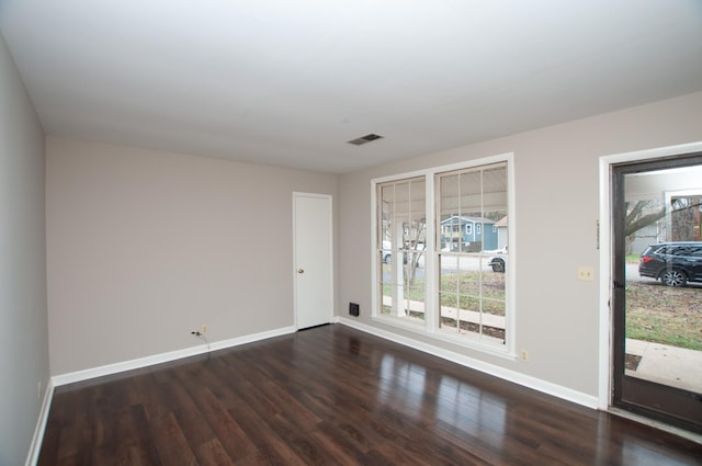 spare room featuring dark hardwood / wood-style floors