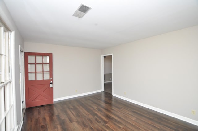 spare room with dark hardwood / wood-style floors