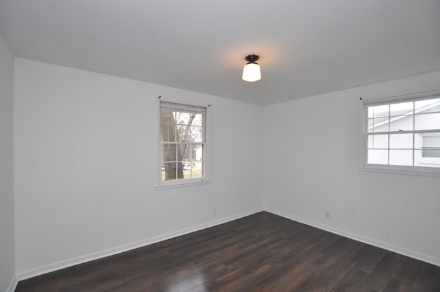 unfurnished room featuring dark wood-type flooring