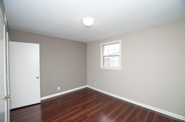 empty room with dark wood-type flooring