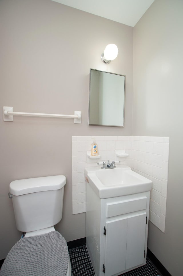 bathroom featuring tile patterned floors, vanity, and toilet