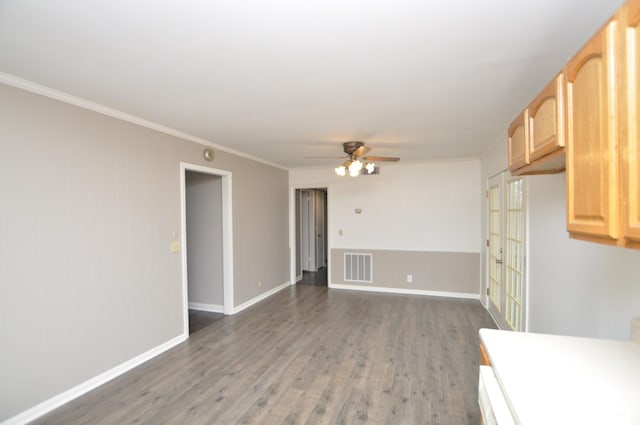 interior space with light brown cabinetry, dark hardwood / wood-style floors, ceiling fan, and crown molding