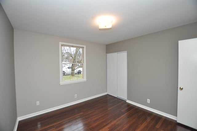 empty room featuring dark hardwood / wood-style flooring