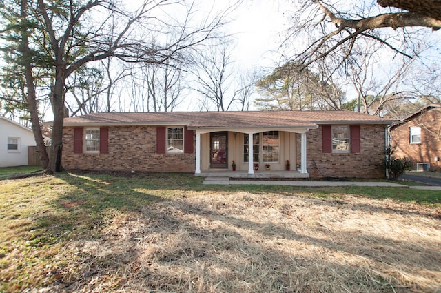 single story home with a porch and a front lawn