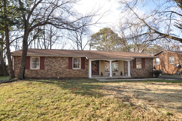 ranch-style home with a front yard and a porch