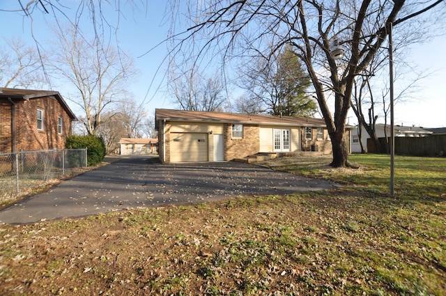 exterior space featuring a lawn and a garage