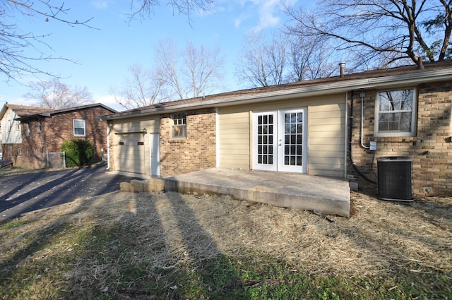 rear view of property featuring cooling unit and french doors
