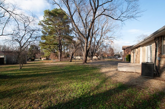 view of yard with cooling unit and a patio