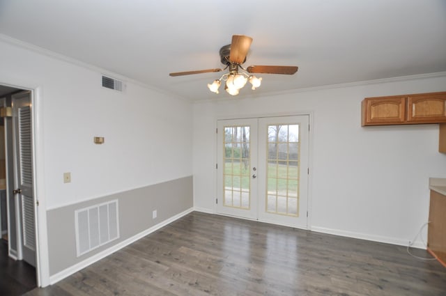 unfurnished dining area with ceiling fan, dark wood-type flooring, crown molding, and french doors