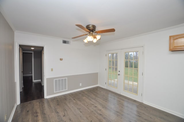 spare room with french doors, dark hardwood / wood-style floors, and crown molding