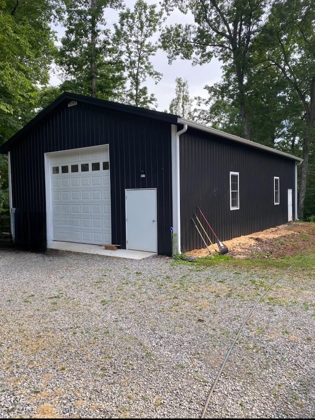 detached garage with gravel driveway