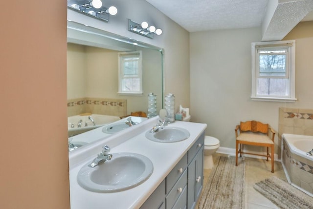 bathroom featuring a sink, a textured ceiling, and a bath