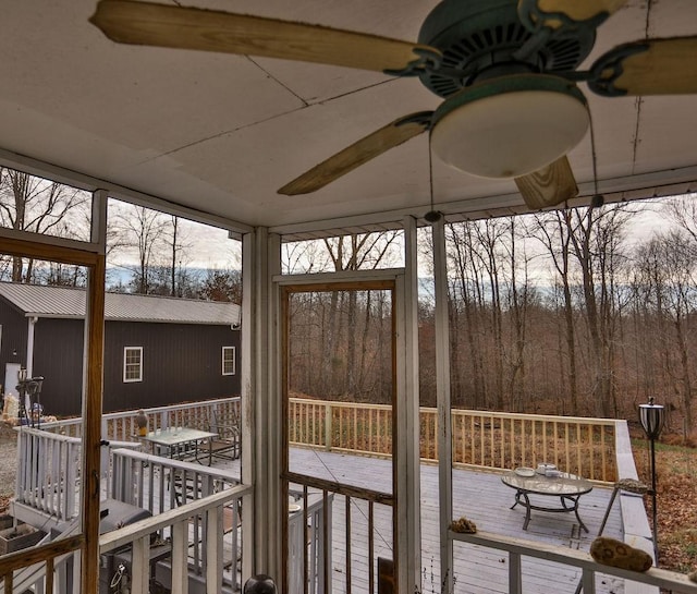 wooden deck with a ceiling fan and outdoor dining space