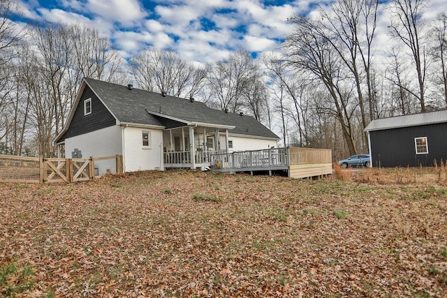 rear view of house featuring a wooden deck