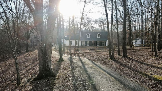 new england style home featuring a storage unit