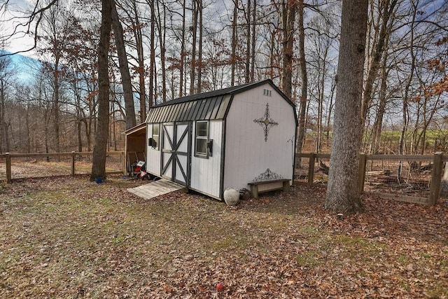 view of shed featuring fence