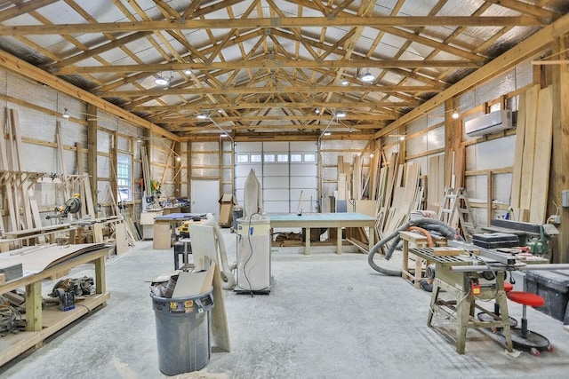 garage with an AC wall unit and a workshop area