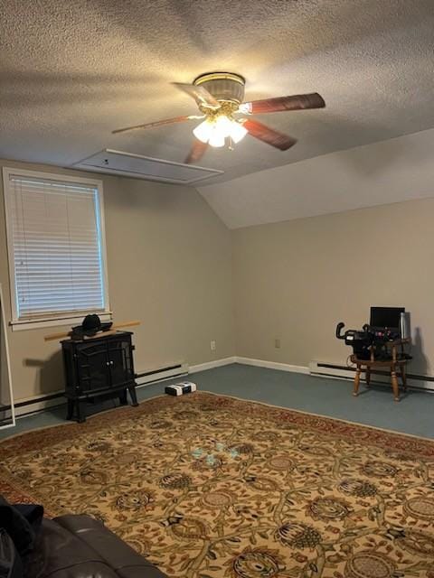 interior space featuring a textured ceiling, ceiling fan, baseboard heating, and vaulted ceiling